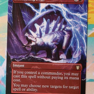 May include: A rectangular trading card titled Deflecting Swat featuring a dark, armoured creature with spikes on its back surrounded by bright blue lightning. The card text includes the word Instant and rules for casting the spell without mana cost.
