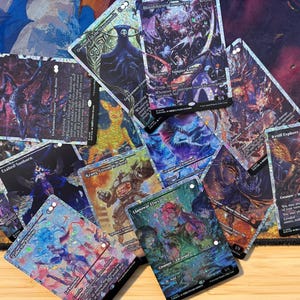 May include: A collection of holographic trading cards scattered across a surface. The cards feature various fantasy illustrations, including characters like Overlord of the Balemark, Bloodthirsty Conqueror, and Llanowar Elves, with visible text and symbols.