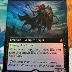 May include: A holographic trading card featuring the "Bloodthirsty Conqueror." The card depicts a warrior with red hair, wielding an axe and shield. Text includes "Creature - Vampire Knight," and flavor text. The card has a 5/5 power and toughness.