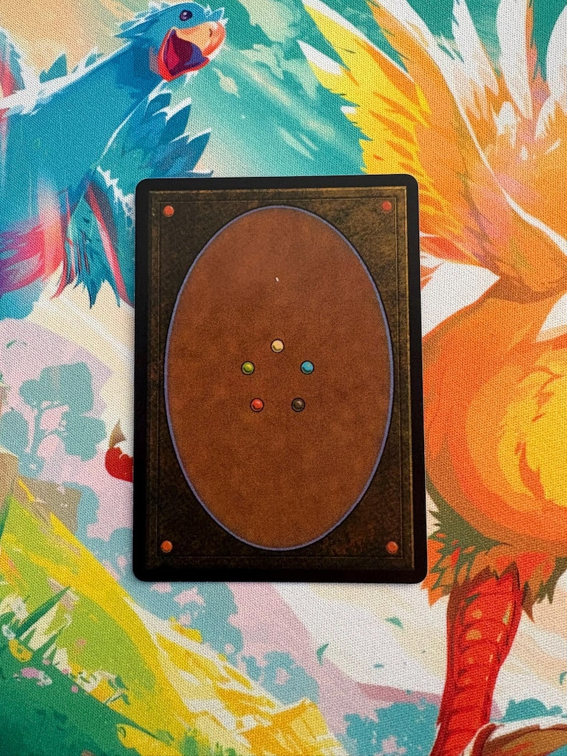 May include: A rectangular trading card with a brown back and a black border. The back of the card features a brown oval with coloured dots. The card is set against a colourful background with illustrations of birds.