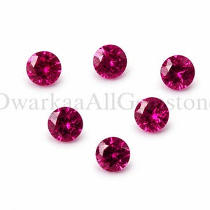 May include: Six round, faceted, deep pink gemstones are arranged on a white background. The gems have a brilliant cut, reflecting light. The image is of gemstones, likely for jewelry making or collecting.