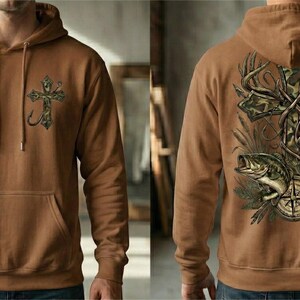 Camo cross hunting and fishing design featuring a detailed camouflage cross wrapped with antlers, a deer buck, a largemouth bass, and a compass illustration. Outdoor faith-themed PNG artwork for t-shirt sublimation and apparel printing.