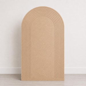 May include: A light brown, flat-surfaced wooden arch panel featuring a series of five concentric, recessed vertical grooves that follow the rounded top edge, creating a layered, linear design on the front face of the upright board.