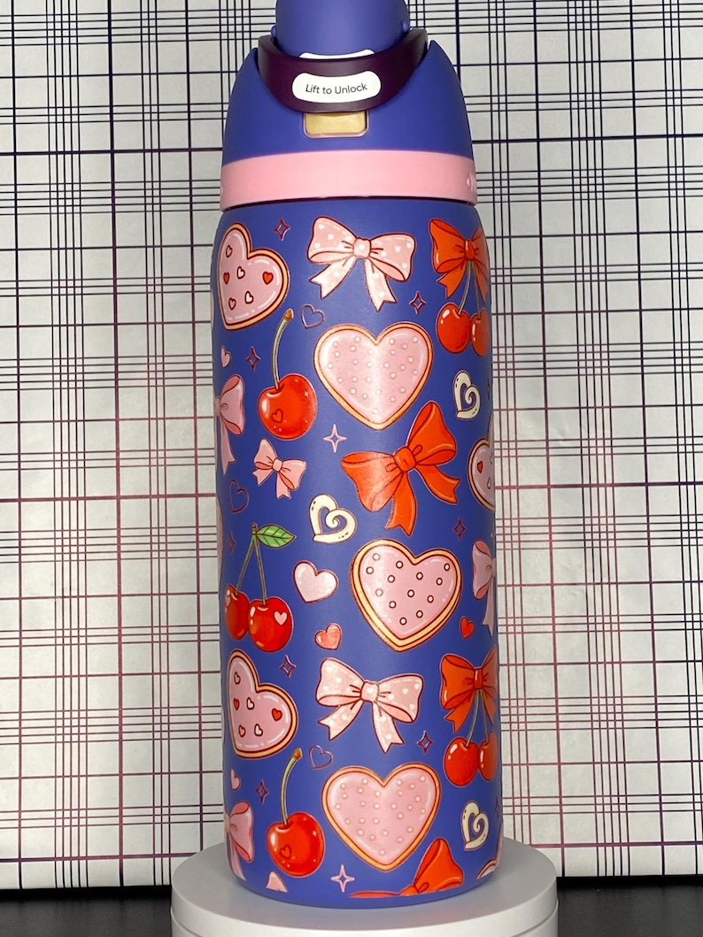 A colorful, patterned water bottle with a variety of heart and bow designs.