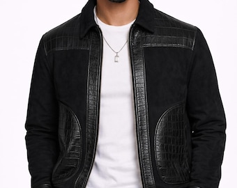 May include: A black jacket with a suede body and leather-look detailing. The jacket has a collared neckline, a zip closure, and a quilted pattern on the shoulders. The model is wearing sunglasses and a silver necklace.
