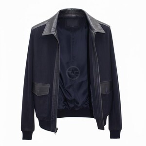 May include: A navy blue bomber jacket with a black leather collar and pocket detailing. The jacket has a zip closure and ribbed hem and cuffs. The interior lining is navy blue with a logo.