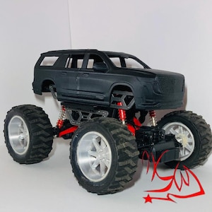 May include: A black monster truck toy with oversized tires and a red suspension system. The truck has a detailed body and silver rims. The tires are large and have a deep tread pattern. The toy is designed for off-road play.