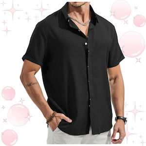 May include: Black short-sleeved shirt with a button-down front and a classic collar. The sleeves are rolled up. The shirt is worn with white trousers. A silver chain necklace and a watch are visible.