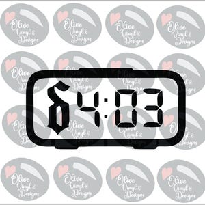 May include: Black digital clock displaying "S4:03" in a bold, stylized font. The clock is rectangular with rounded corners. The background features multiple gray ovals with a pink heart and the text "Olive Vinyl & Designs".