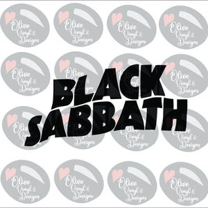 May include: A collection of stickers featuring the text "BLACK SABBATH" in bold black letters. The stickers also include a gray oval design with a pink heart and the text "Olive Vinyl & Designs" in white.