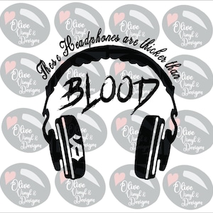 May include: Black graphic of headphones with the word "BLOOD" in bold letters. The text "These headphones are thicker than" is arched above the headphones. The background has gray ovals with pink hearts and the text "Olive Vinyl & Designs".