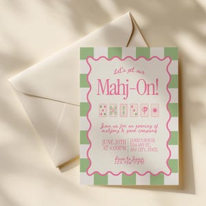 May include: A rectangular invitation card with a green and white striped border and a scalloped pink frame. The text reads: Let's get our Mahj-On! Join us for an evening of mahjong & good company. JUNE 20TH AT 6:00PM. JAMIE'S HOUSE 1234 ANY ST., ANY CITY, STATE. RSVP to Jamie 123-456-7890.