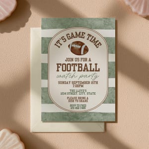 May include: A rectangular invitation card featuring horizontal sage green and white stripes. The center displays a brown football graphic and text reading: IT'S GAME TIME, JOIN US FOR A FOOTBALL WATCH PARTY, SUNDAY SEPTEMBER 15TH 7:00PM, THE LLOYD'S 1234 STREET, CITY, STATE, PLEASE BRING A DISH TO SHARE, RSVP TO FRED 123-456-7489.