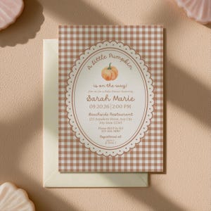 May include: A rectangular baby shower invitation card featuring a brown and white gingham pattern background. The center has an oval scalloped frame with a pumpkin illustration and text reading A little pumpkin is on the way! Sarah Marie 09.20.26 2:00 PM.