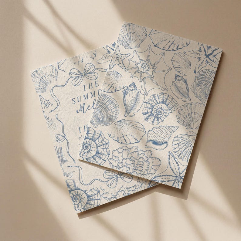 May include: Two rectangular cards with a beige background and a blue seashell pattern. The cards have a variety of seashells, starfish, and coral illustrations. The text "THE SUMMER Mel" is visible on one card.