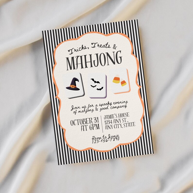 May include: A rectangular invitation card with a black and white vertical striped border and a cream-colored center featuring an orange scalloped frame. The text reads Tricks, Treats & MAHJONG, with illustrations of a witch hat, bats, and candy corn.