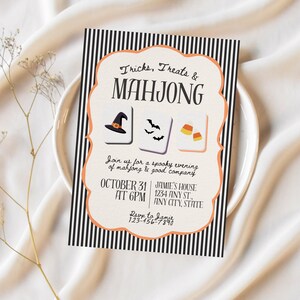 May include: A rectangular Halloween party invitation with a black and white vertical striped border and an orange scalloped frame. It features the text Tricks, Treats & MAHJONG, three mahjong tiles with a witch hat, bats, and candy corn, and event details.