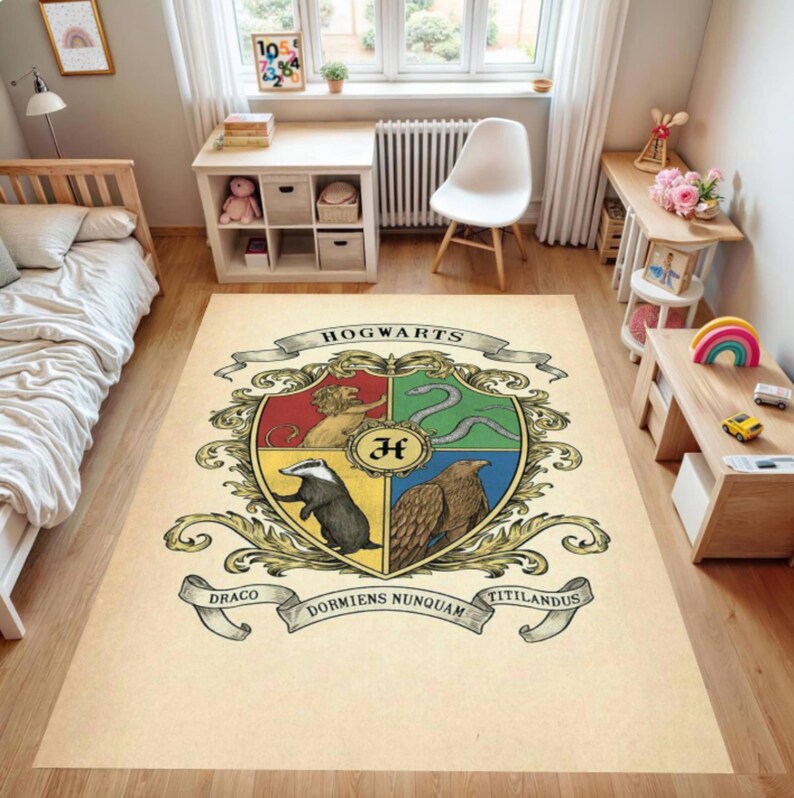May include: A rectangular beige rug featuring the Hogwarts crest. The crest is divided into four sections, each with a different animal and color. The rug has the words "Hogwarts", "Draco", "Dormiens Nunquam", and "Titillandus" on it.