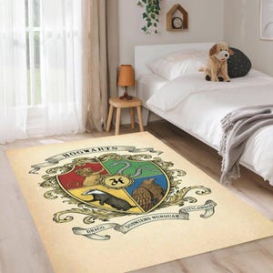 May include: A rectangular beige rug featuring the Hogwarts crest. The crest is a shield divided into four sections, each with a different animal and color. The rug has the words "HOGWARTS" and "DORMENS NUNQUAM TITILLANDUS" on it.