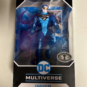 May include: A blue action figure of the DC Comics character Eradicator, packaged in a black and blue box. The figure is wearing a blue suit, cape, and gold-tinted goggles. The box features the DC Multiverse logo and the text "Eradicator".