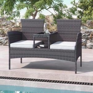 Puede incluir: Un sof&aacute; de mimbre gris oscuro con una peque&ntilde;a mesa entre los asientos. El sof&aacute; tiene cojines blancos y est&aacute; colocado cerca de una piscina. Una botella y vasos est&aacute;n sobre la mesa. El sof&aacute; est&aacute; dise&ntilde;ado para uso en exteriores.