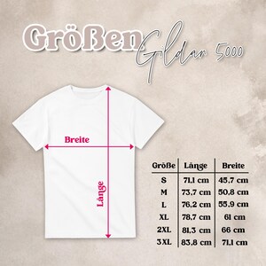 May include: A white t-shirt with a size chart labeled Gildan 5000. The chart displays measurements in centimeters for sizes S through 3XL, including length and width. Red arrows on the shirt indicate the points of measurement for length and width.