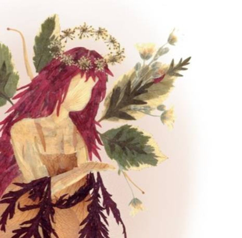 May include: A dried flower art piece depicting a woman with long red hair wearing a crown of dried flowers. The woman is wearing a dress made of dried flowers and leaves. The background is a light pink.
