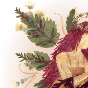 May include: A floral art piece featuring a woman with long, dark red hair. The woman is made of dried flowers and leaves, and she is wearing a dress made of the same materials. The background is a light pink.