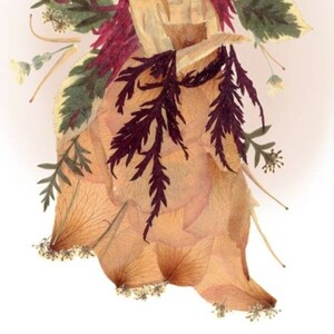 May include: A dried flower arrangement featuring a variety of dried flowers and leaves, including a large rose, ferns, and small white flowers. The arrangement is in shades of brown, beige, and purple.