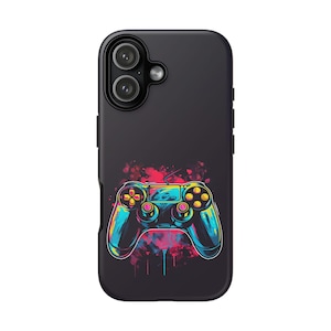 May include: Black phone case with a colourful video game controller design. The controller is rendered in blue, yellow, and pink against a splash of paint. The case has a sleek, modern design, suitable for various phone models.