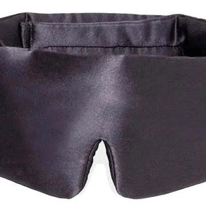 May include: A dark purple sleep mask made from a smooth, satin-like fabric. The mask is shaped to fit the face, with eye openings and an elasticated band for securing. It is designed to block out light for improved sleep.