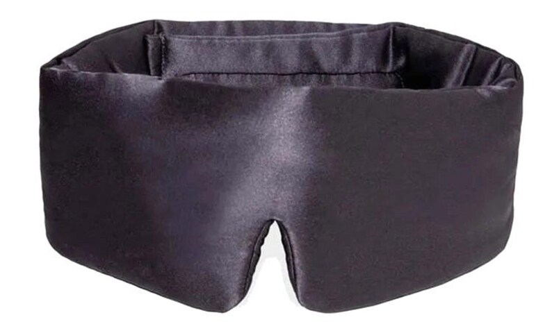 May include: A dark purple sleep mask made from a smooth, satin-like fabric. The mask is shaped to fit the face, with eye openings and an elasticated band for securing. It is designed to block out light for improved sleep.