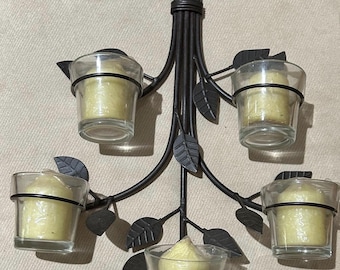 This item is a vintage metal wall sconce designed to hold votive or tea light candles. It features a "flower-branches" or "twig" motif.