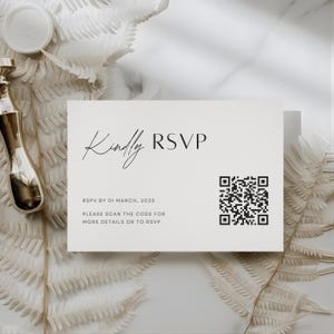 May include: A cream-colored RSVP card with the words "Kindly RSVP" in elegant script. The card includes a QR code and the date "01 March, 2025". The card is surrounded by white decorative elements.