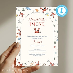 May include: A cream-colored invitation with a nautical theme, featuring crabs, anchors, and fish. The text reads "Pinch Me! I'm One" and invites guests to a first birthday party for James. Includes party details and RSVP information.