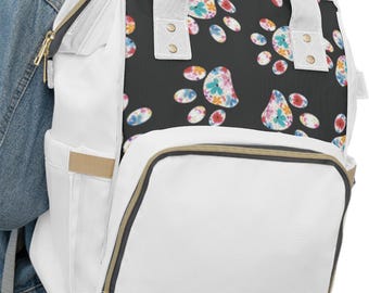 Sac à dos à langer floral coloré à imprimé pattes