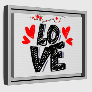 以下が含まれることがあります： 黒い手書き文字で「LOVE」という言葉が書かれた、額入りのキャンバスプリント。赤いハートが単語の周りに散らばっており、上部にはハートの装飾的なつるがあります。キャンバスはグレーのフレームにセットされています。