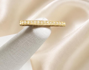May include: A gold-toned bar hair clip featuring a single row of small, round, white pearls embedded along the top surface. The rectangular hair accessory has a polished metallic finish and a straight, elongated design with a secure clasp mechanism.