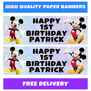 May include: Two paper banners with Mickey Mouse illustrations. The banners read "HAPPY 1ST BIRTHDAY PATRICK" in large black letters. Mickey Mouse is wearing red shorts, yellow shoes, and white gloves. The top banner has a blue background with the text "HIGH QUALITY PAPER BANNERS".