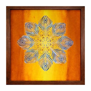 May include: A framed artwork featuring a symmetrical, stylized feather design in shades of yellow, blue, and white against an orange background. The artwork is enclosed in a dark brown wooden frame, creating a striking contrast.