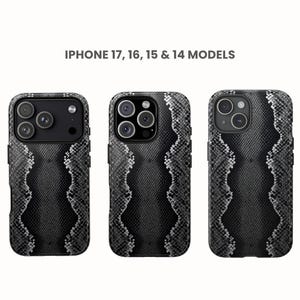May include: Three iPhone cases with a black and gray snakeskin pattern. The cases are designed for iPhone 17, 16, 15, and 14 models. The cases have a wavy design down the center.