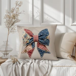 May include: A decorative pillow with a large bow design. The bow is made of patchwork fabric in red, white, and blue patterns, including stars, stripes, and floral prints. Wooden buttons accent the bow's center.