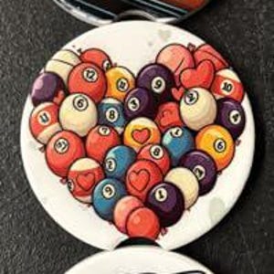 May include: Three white round coasters with unique designs. One features a pumpkin-headed skeleton playing pool, another a heart made of billiard balls, and the last a shark playing pool.