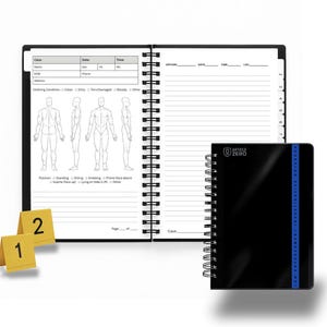 May include: A spiral-bound notebook with a black cover and a blue stripe, next to an open notebook with lined pages and a body diagram. The notebook has the text "ARTICLE ZERO" on the cover. Two yellow evidence markers are in the foreground.