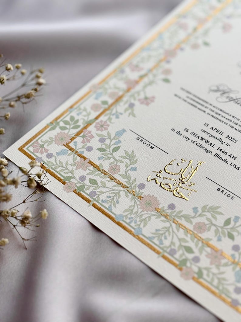 May include: Elegant wedding invitation with floral border in pastel colors. The invitation features gold foil accents and text, including the date April 15, 2025, and the city of Chicago, Illinois, USA. The words "Groom" and "Bride" are also visible.