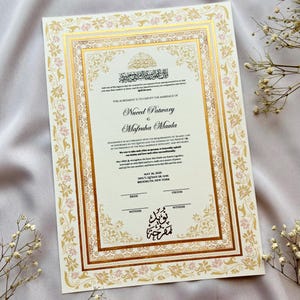 May include: A wedding certificate with an elaborate gold and pink floral design. The document includes English and Arabic text, with the names Nuced Patwary and Mafruha Maula. The date May 26, 2025, and location Brooklyn, New York are also visible.