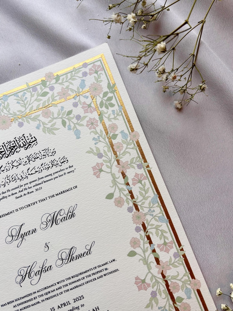 May include: Elegant wedding invitation with floral border in soft pink, blue, and green hues. The invitation features gold accents and calligraphy with the names Ayan Malik and Hafsa Ahmed, and the date April 15, 2025.