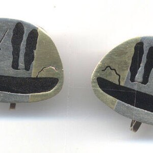 May include: A pair of silver tone earrings with a black and white silhouette design of people in a boat. The earrings have a multi-coloured background with shades of pink, green, and gold.