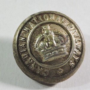 May include: A silver button with a crown and the text "Canadian National Railways" around the edge.