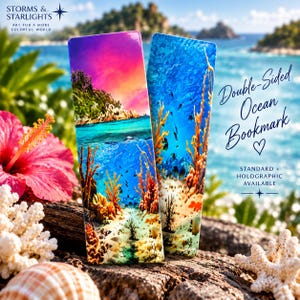 May include: Two rectangular bookmarks featuring vibrant underwater ocean scenes with coral reefs, tropical fish, and sandy sea floors. The designs include a sunset sky above the water and deep blue aquatic depths with detailed marine life imagery.
